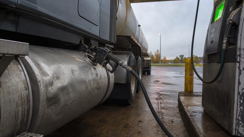 A diesel nozzle fills a tractor's saddle tank at dawn at a fuel island near Woodstock, Ont.